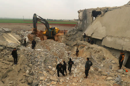 A front loader removes rubble from a damaged mosque after an airstrike on the rebel-held village of al-Jina, Aleppo province in northwest Syria March 17, 2017. REUTERS/Ammar Abdullah