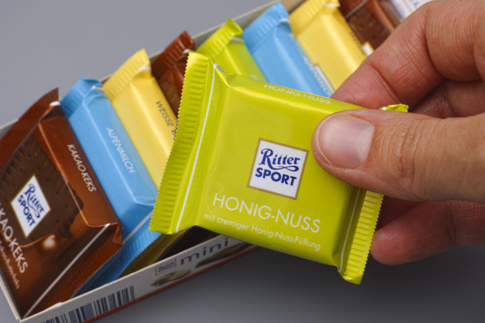 Tambov, Russian Federation - January 27, 2016: Ritter sport chocolate mini in woman hand. Studio shot.