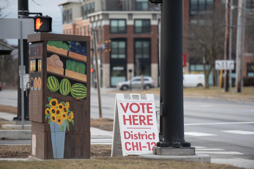 A sign on Shelburne Road at the entrance of Baldwin Avenue shows the way to the Orchard School polling station in South Burlington on Town Meeting Day, Tuesday, March 5, 2024.