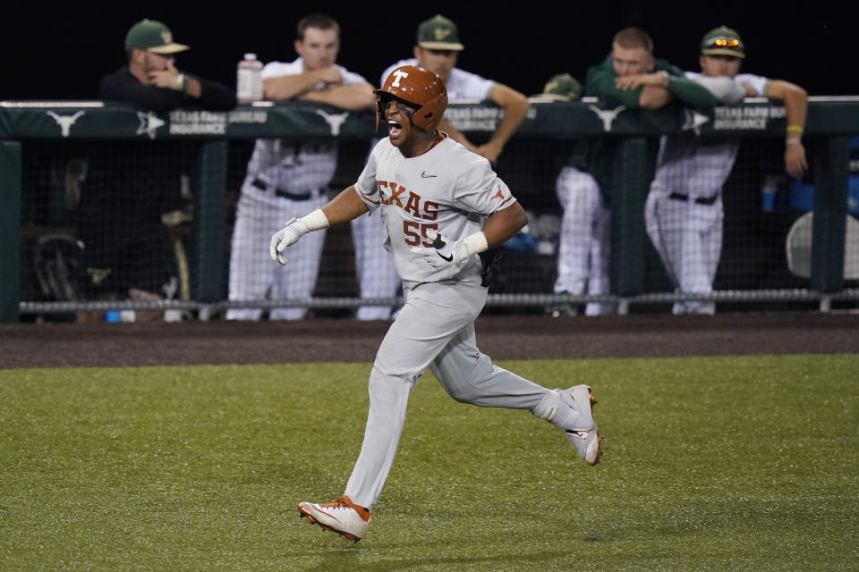 Texas' Camryn Williams celebrates a two-run homer against South Florida as he rounds the bases during the seventh inning of an NCAA Super Regional college baseball game, Sunday, June 13, 2021, in Austin, Texas. (AP Photo/Eric Gay)