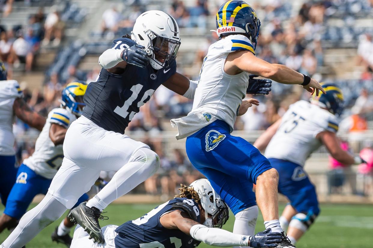 Penn State defensive end Jameial Lyons (19) and defensive tackle Zane Durant (28) record a QB hurry on Delaware's Zach Marker during the second of a NCAA football game Saturday, Sept. 9, 2023, in State College, Pa.