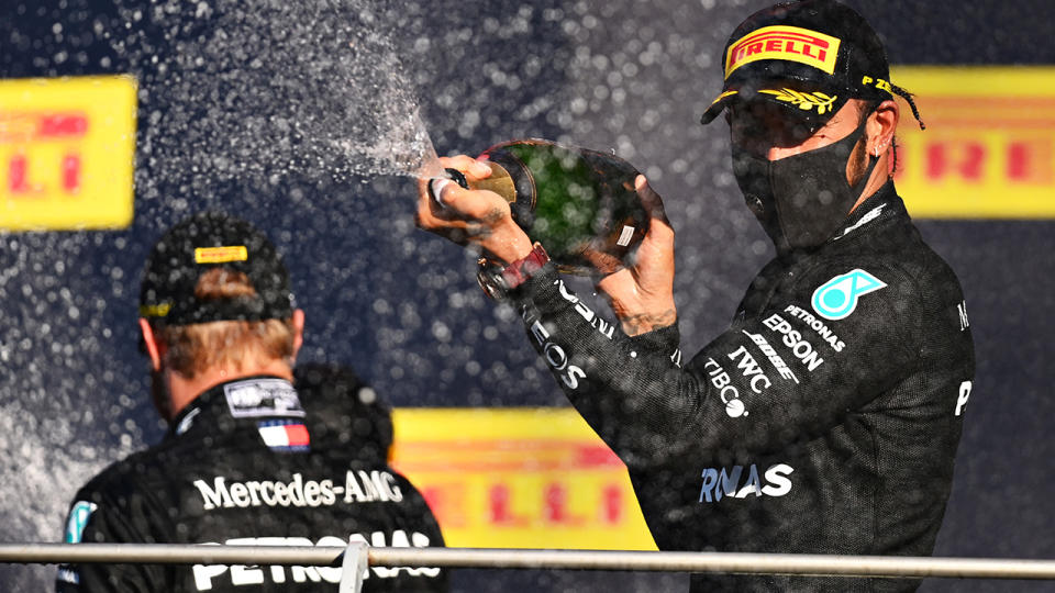 Race winner Lewis Hamilton and Mercedes GP celebrates on the podium after the F1 Grand Prix of Tuscany at Mugello Circuit. (Photo by Clive Mason - Formula 1/Formula 1 via Getty Images)
