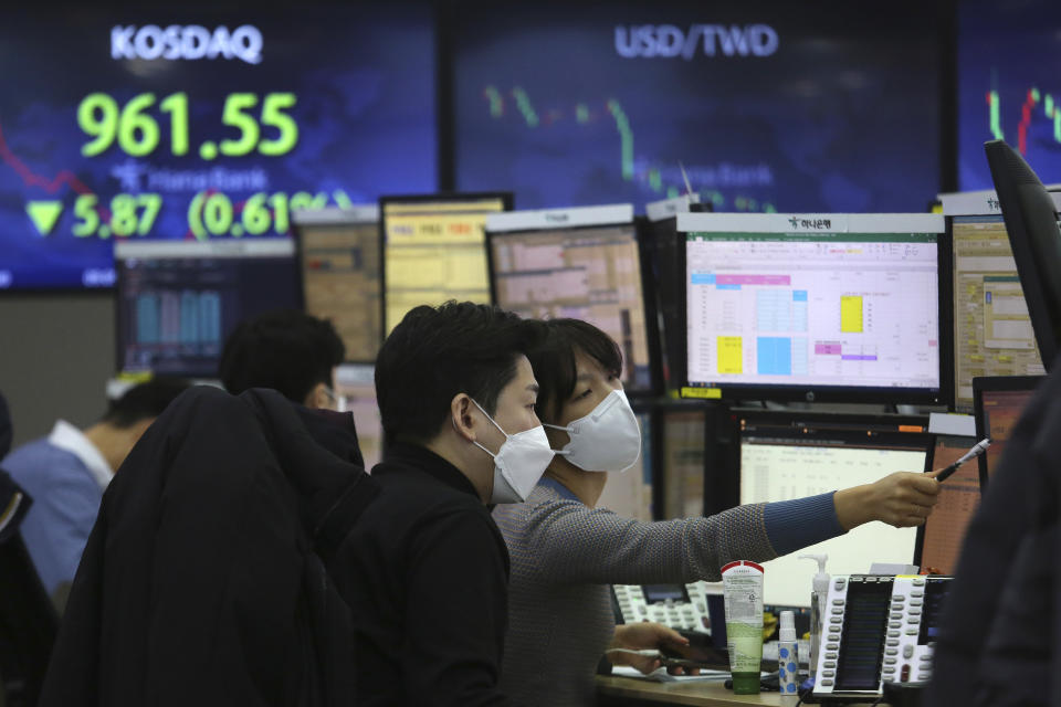 Currency traders watch monitors at the foreign exchange dealing room of the KEB Hana Bank headquarters in Seoul, South Korea, Monday, Feb. 8, 2021. Asian shares mostly rose Monday, tracking a rally on Wall Street last week, with Japan's benchmark momentarily reaching three-decade highs, on growing optimism about the global economy. (AP Photo/Ahn Young-joon)