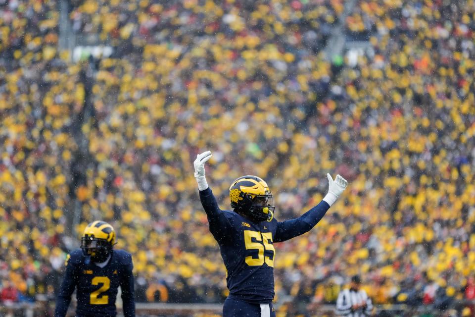 Michigan linebacker David Ojabo cheers the crowd before a play against Ohio State during the first half at Michigan Stadium in Ann Arbor on Saturday, Nov. 27, 2021.