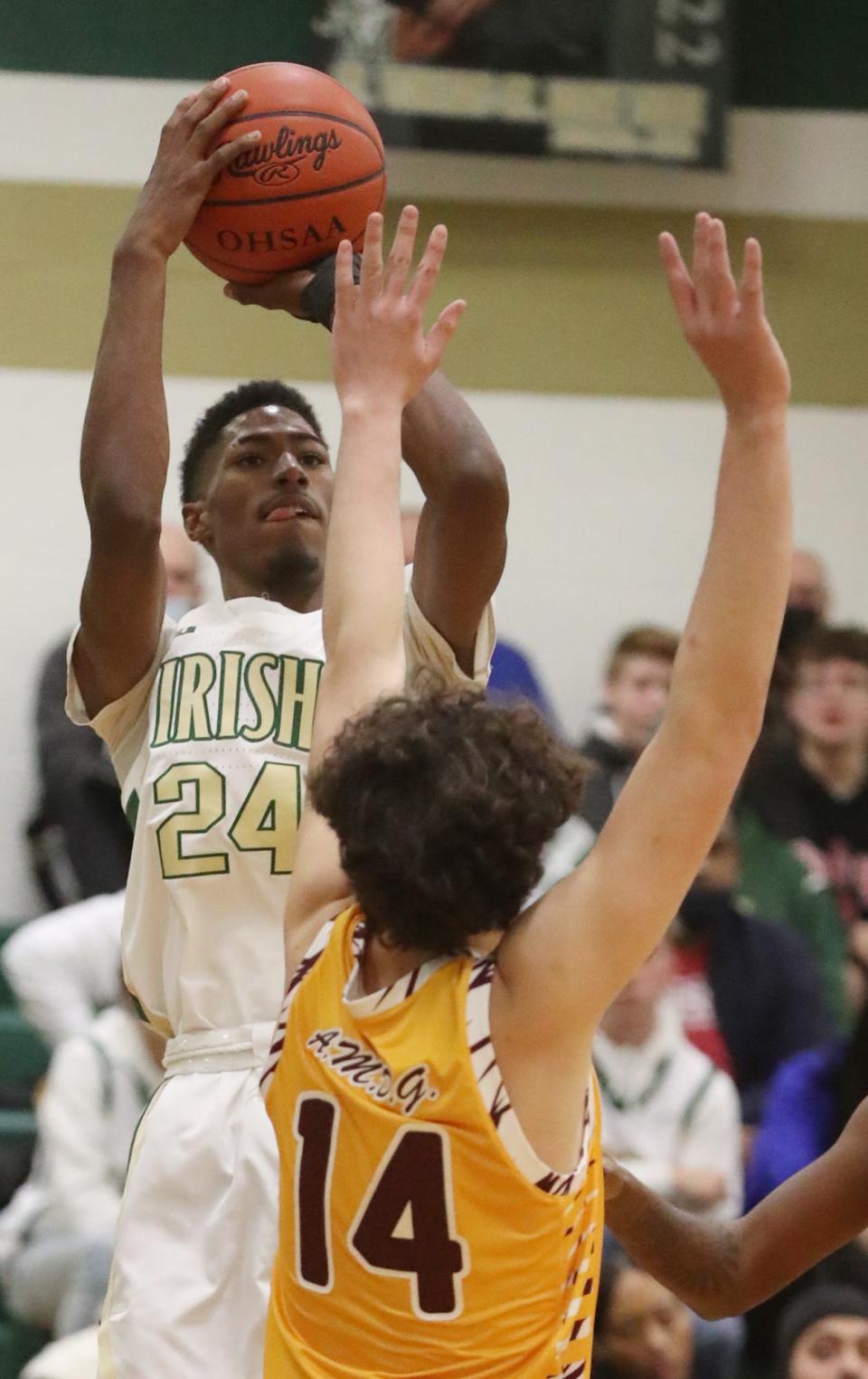 St. Vincent-St. Mary's Sencire Harris shoots over Walsh Jesuit's Max Matta during their game in The LeBron James Arena at St. Vincent-St. Mary High School in Akron.