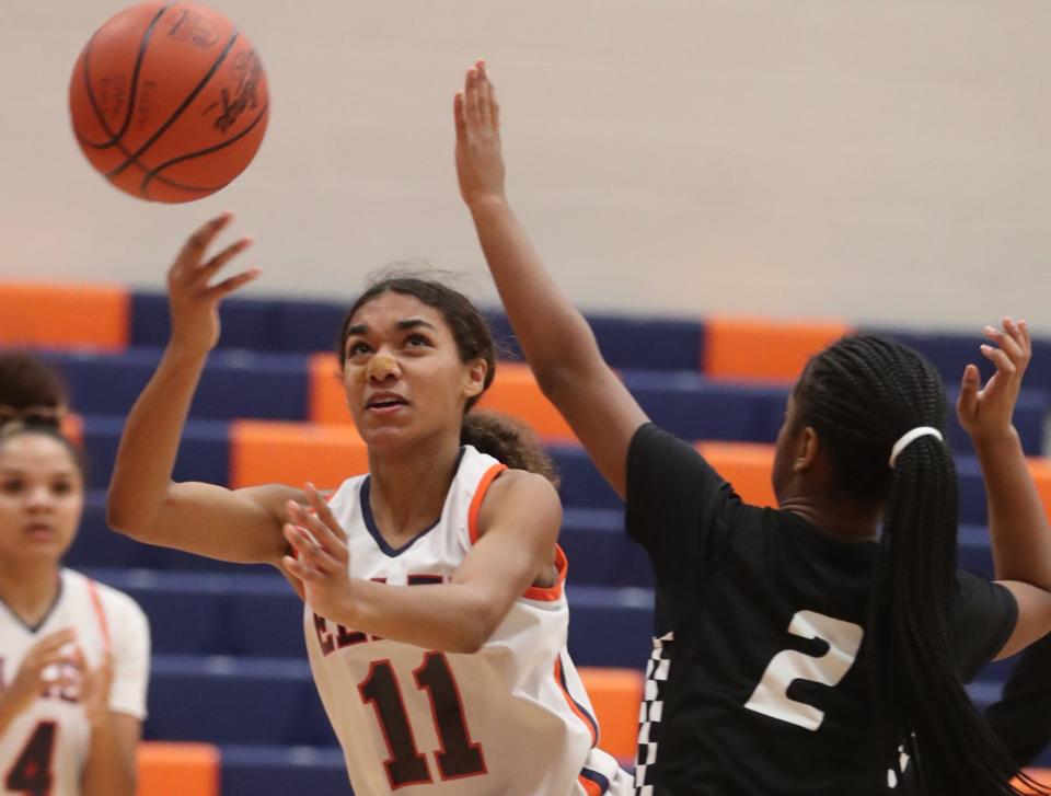 Ellet's Trinity Brown shoots as Buchtel's Aaliyah Golden defends in the first half of Ellet's 63-24 City Series win Monday. [Mike Cardew/Beacon Journal]