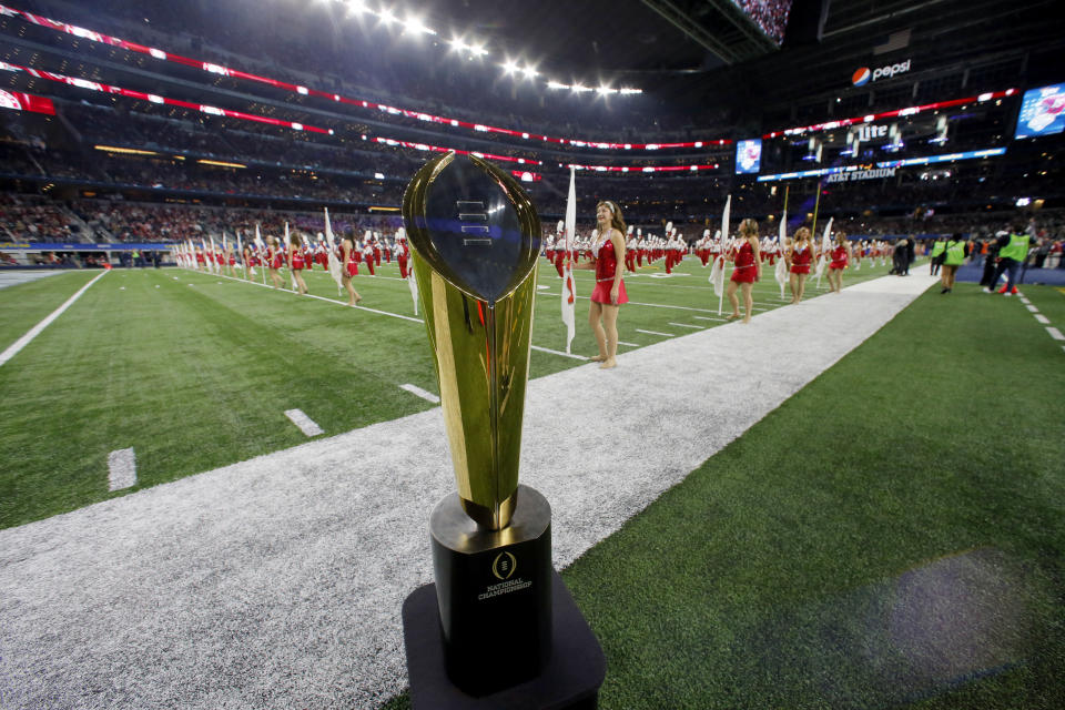 A  College Football Playoff National Championship Trophy is seen on the field before the Cotton Bowl NCAA college football semifinal playoff game between Alabama and Michigan State, Thursday, Dec. 31, 2015, in Arlington, Texas. (AP Photo/Tony Gutierrez)