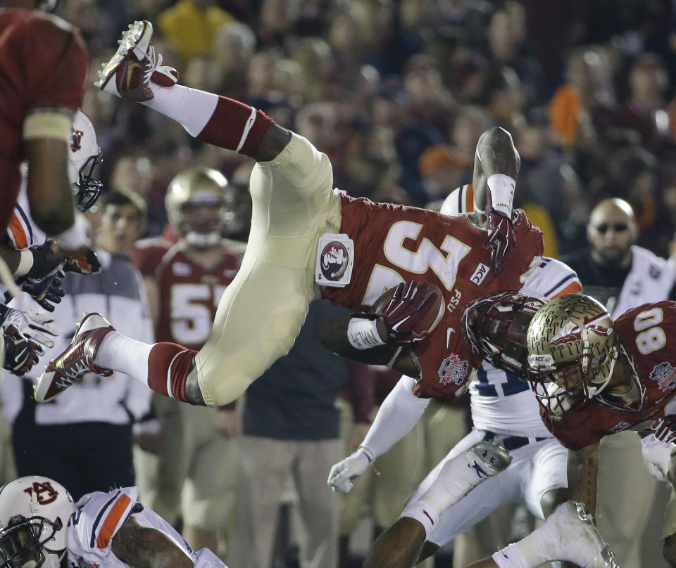 Florida State's James Wilder Jr. is upended during the second half of the NCAA BCS National Championship college football game against Auburn Monday, Jan. 6, 2014, in Pasadena, Calif. (AP Photo/David J. Phillip)