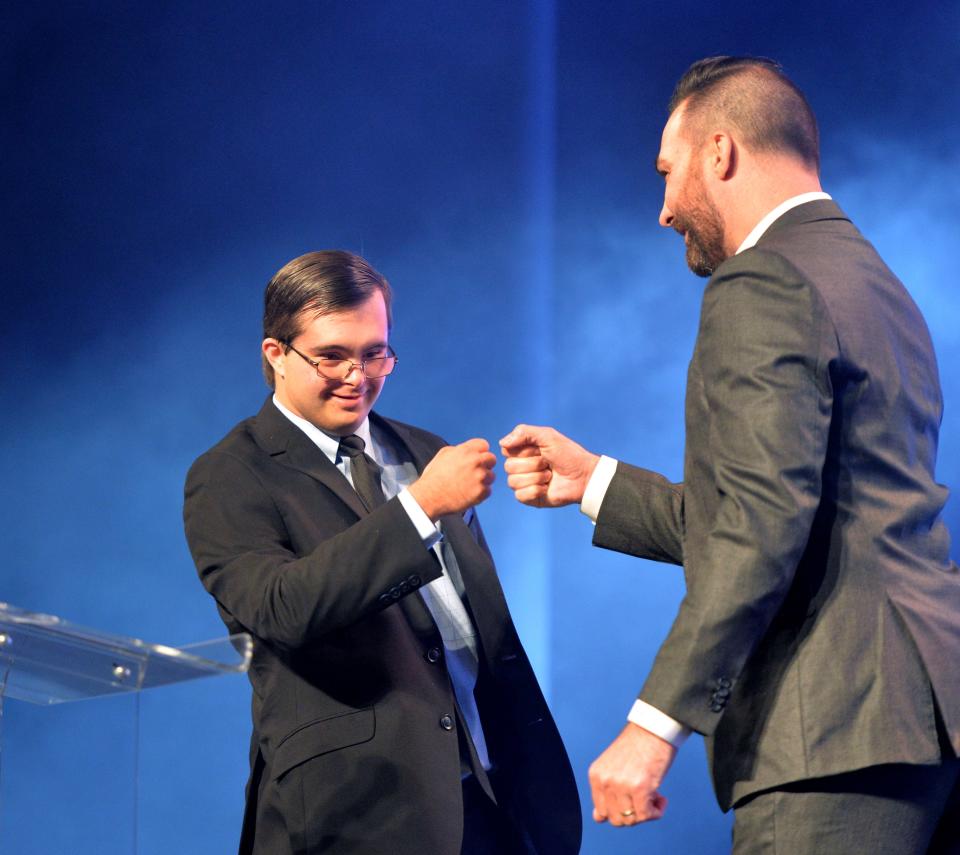 Andrew Feduccia, left, a member of the Riverview High football student training team, fist bumps emcee Ryan O'Leary as he is named winner of  the Courage Award at the 2023 Sarasota, Manatee, Charlotte High School Sports Awards Wednesday evening, June 7th at the Van Wezel Performing Arts Hall.