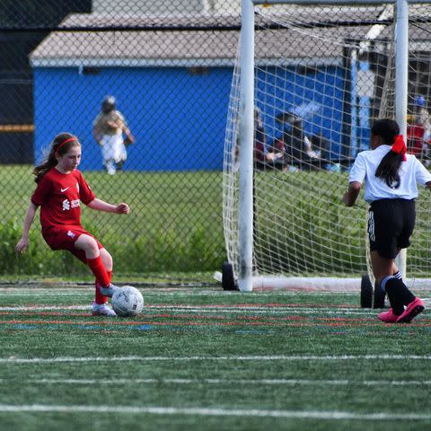 <p>Sari Hitchins</p> Clare (Age 10) playing soccer