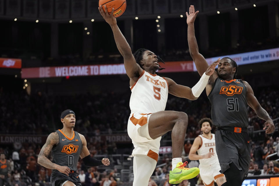 Texas guard Marcus Carr (5) drives to the basket against Oklahoma State guard John-Michael Wright (51) during the second half of an NCAA college basketball game in Austin, Texas, Tuesday, Jan. 24, 2023. (AP Photo/Eric Gay)