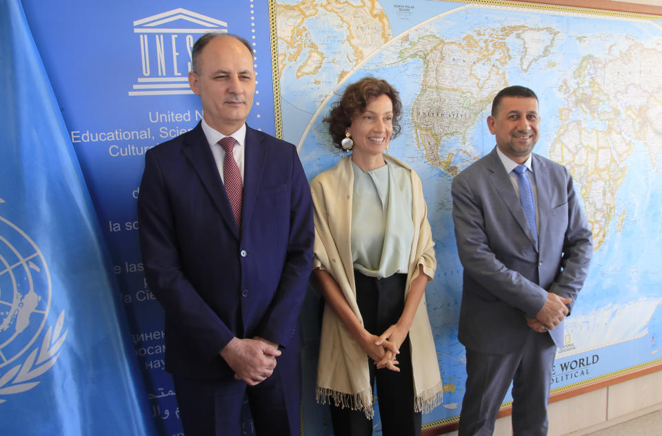 Iraq's Culture Minister Abdulamir al-Dafar Hamdani, left, and Governor of the province Nineveh Mansour al-Mareed, right, are welcomed by UNESCO'S Director-General Audrey Azoulay at the UNESCO's headquarters in Paris, Wednesday, Sept. 11. 2019. Iraqi officials meet at the UN's cultural agency in Paris to discuss plans for an ambitious $100 million reconstruction of the Islamic State-ravaged city of Mosul. (AP Photo/Michel Euler)