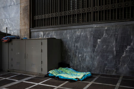 Blankets belonging to a homeless person are seen on a pavement in central Athens, Greece, February 15, 2017. REUTERS/Alkis Konstantinidis