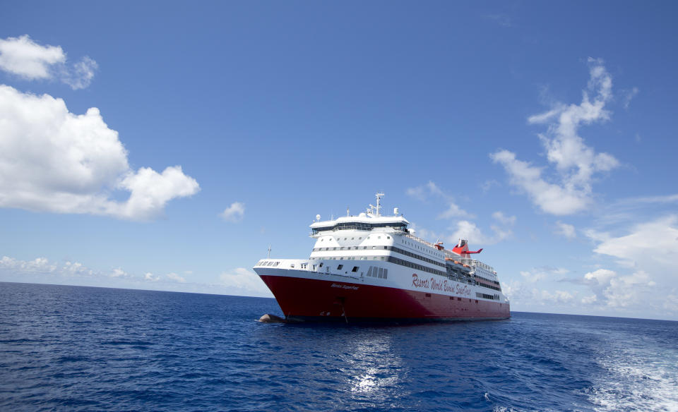 In this Sept. 10, 2013 photo, Resorts World Bimini's Super Fast ship sits off shore, after unloading passengers from Miami for a day trip in Bimini, Bahamas. Every time a cruise ship docks in Bimini, the population of this tiny archipelago just 50 miles off the coast of Miami could nearly double. That may be profitable for a place that lives off tourism. But many worry the recent launch of a new cruise line disgorging hundreds of visitors each day could be too much of a good thing. (AP Photo/J Pat Carter)