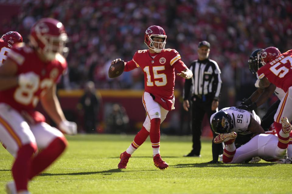 Kansas City Chiefs quarterback Patrick Mahomes runs as he throws as touchdown pass to wide receiver Marquez Valdes-Scantling during the first half of an NFL football game against the Jacksonville Jaguars Sunday, Nov. 13, 2022, in Kansas City, Mo. (AP Photo/Charlie Riedel)