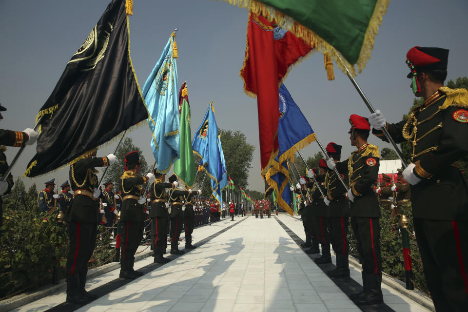 Members of the honor guard stand at attention during the Independence Day celebrations at Defense Ministry in Kabul, Afghanistan, Tuesday, Aug. 18, 2020. Several mortar shells slammed into various part of Kabul on Tuesday morning as Afghans marked their country's Independence Day amid new uncertainties over the start of talks between the Taliban and the Kabul government. (AP Photo/Rahmat Gul)