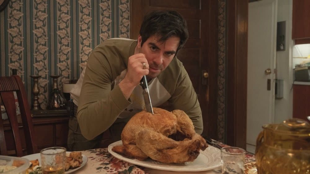 a person sitting at a table with a plate of food