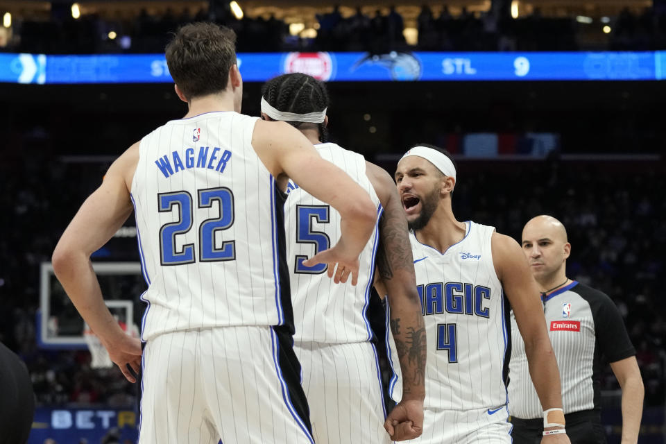 Orlando Magic forward Paolo Banchero (5) is congratlated by guard Jalen Suggs (4) after Banchero's game winning basket during the second half of an NBA basketball game against the Detroit Pistons, Saturday, Feb. 24, 2024, in Detroit. (AP Photo/Carlos Osorio)