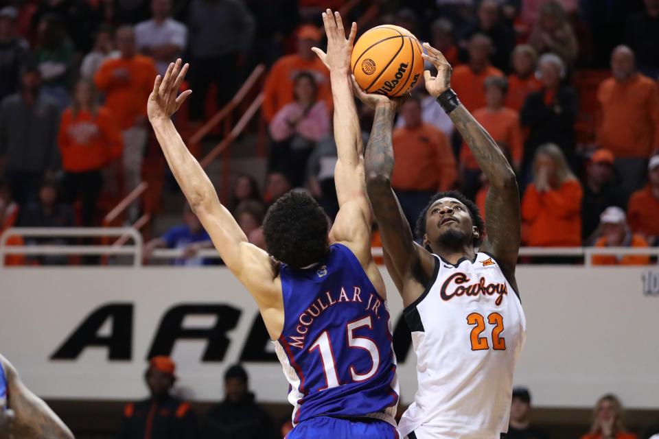 OSU forward Kalib Boone (22) puts up a shot beside Kansas guard Kevin McCullar Jr. (15) during the Jayhawks' win Tuesday night in Stillwater.