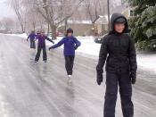 Kids skate on an ice-covered street in Kingston, Ont., on Saturday, December 21, 2013. THE CANADIAN PRESS/Andrea Loken
