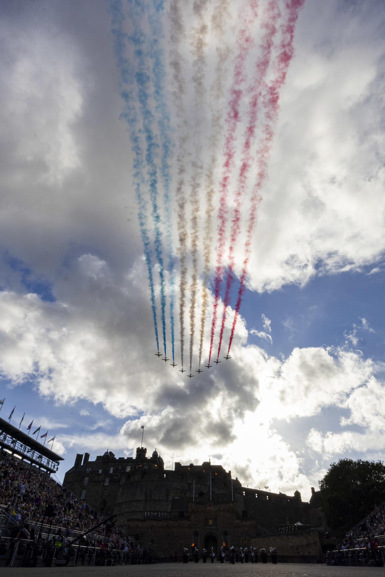 Red Arrows planes flying over the Royal Edinburgh Military Tattoo leaving blue, white and red trails