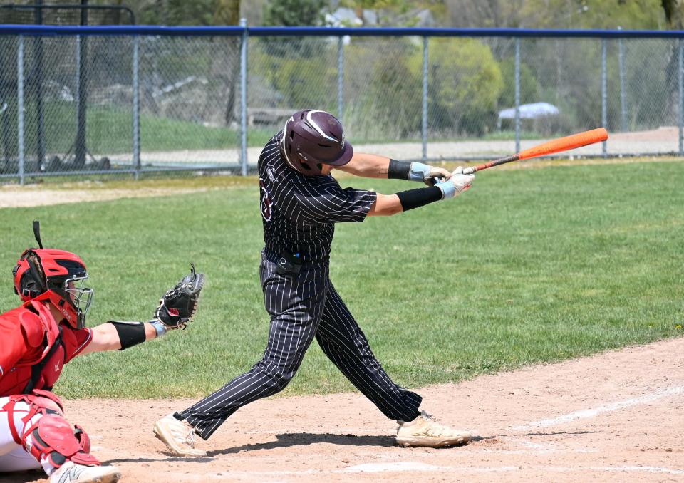 Charlevoix's Bryce Johnson drives a pitch through the infield during Saturday's game against Spring Lake.