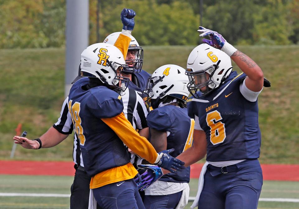 Siena Heights celebrates a touchdown during Saturday's game against St. Ambrose.