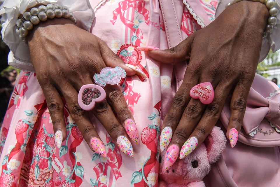 Woman showing rings at Lolita-style fashion show