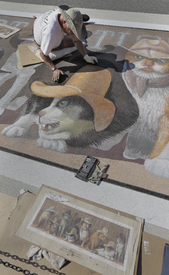 Artist Bryan Moon works on his 3D pavement art project during the Sarasota Chalk Festival Wednesday, Oct. 31, 2012, in Sarasota, Fla. The annual festival begins this week and runs through Nov. 6.(AP Photo/Chris O'Meara)