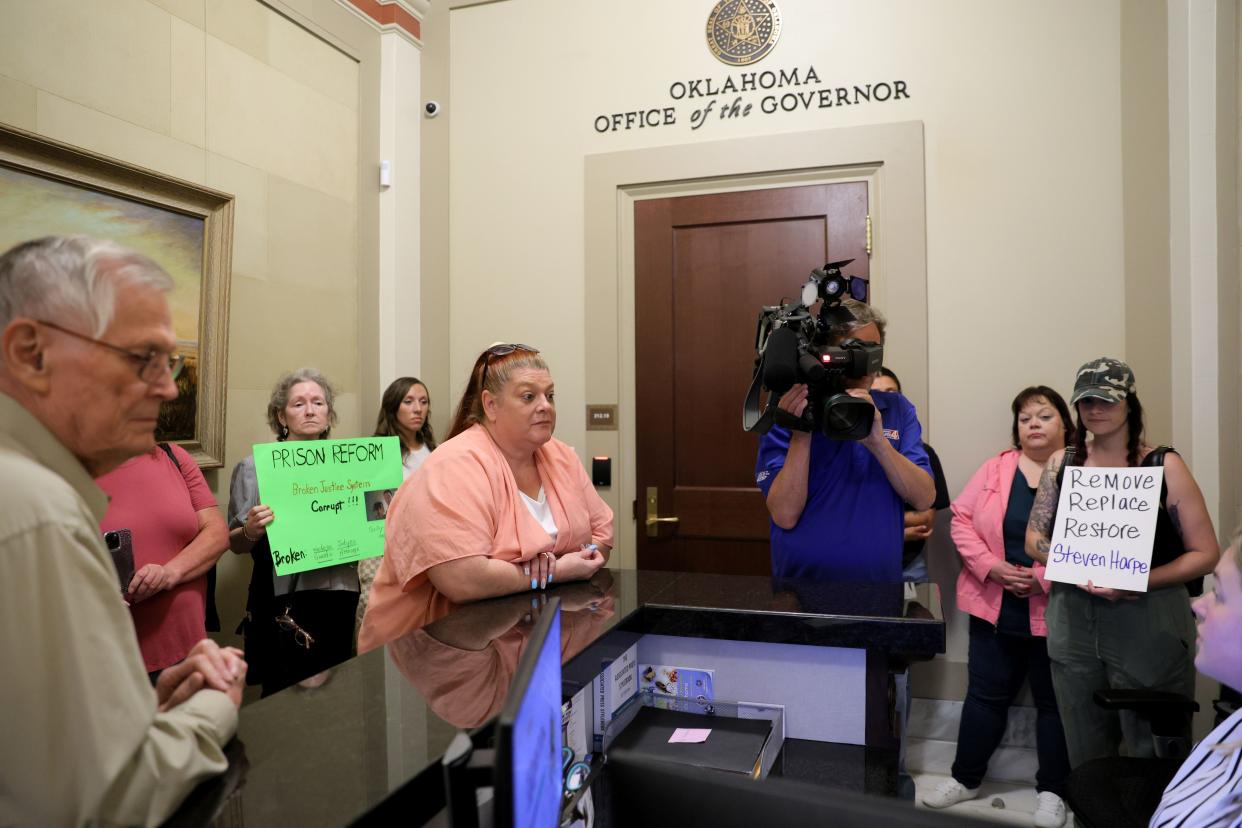 Emily Barnes, with the criminal justice advocacy group Hooked on Justice, asks to meet with Gov. Kevin Stitt on Wednesday outside his office at the state Capitol.