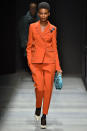 <p>Model wears an orange double-breasted pantsuit at the fall 2018 Bottega Veneta show. (Photo: Getty Images) </p>