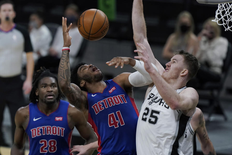 Detroit Pistons forward Saddiq Bey (41) is fouled by San Antonio Spurs center Jakob Poeltl (25) during the second half of an NBA basketball game in San Antonio, Thursday, April 22, 2021. (AP Photo/Eric Gay)