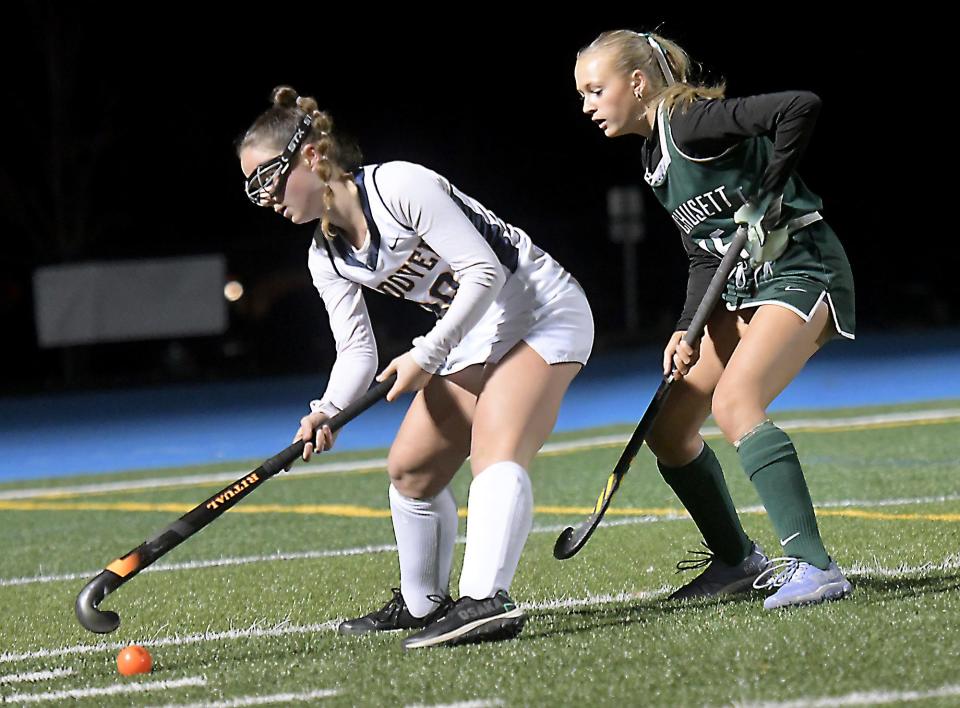 Wachusett's Emmy Johnson applies pressure as Andover's Bella DiFiore works the ball along the sideline.