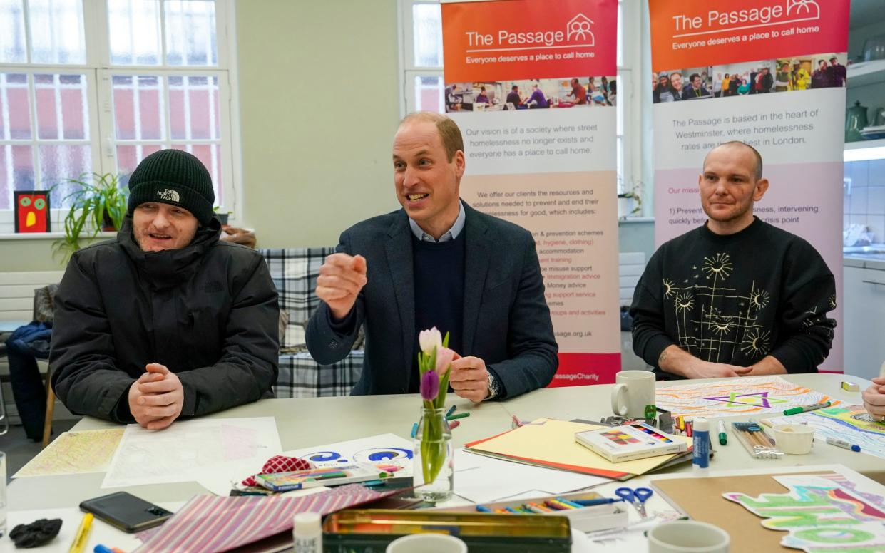 The Prince of Wales sits with residents Gary and Marc as he visits The Passage and officially opens two residential buildings - Bentley House and Passage House - on February 23 in London - WPA Pool/Getty Images Europe