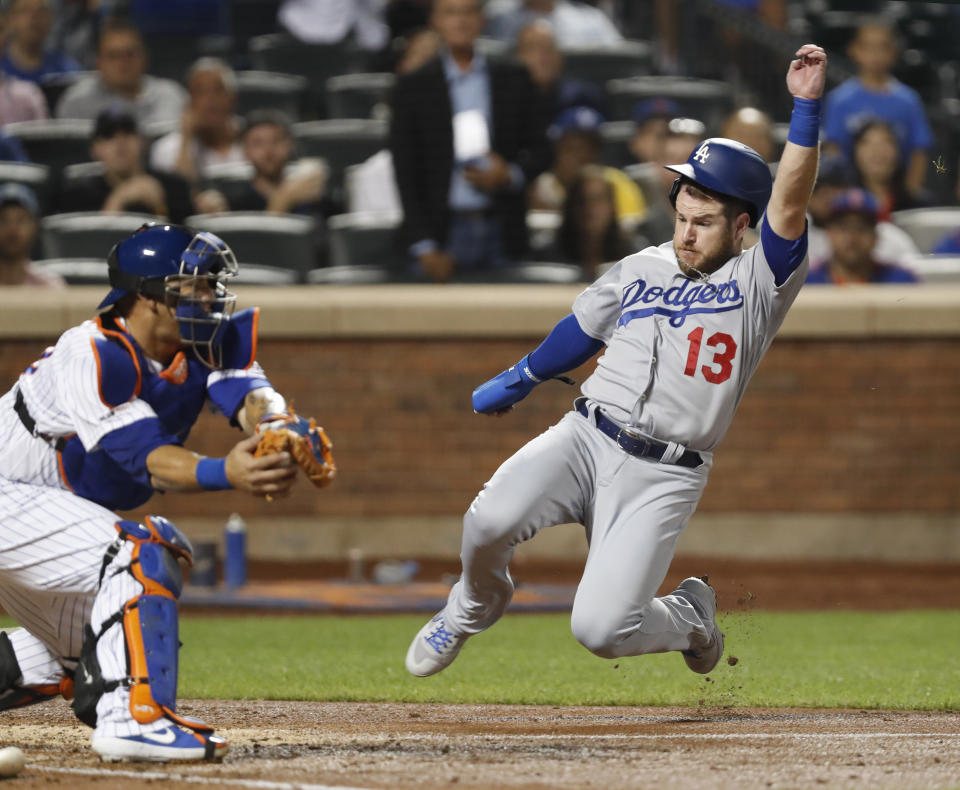 New York Mets catcher Wilson Ramos, left, has the ball in hi glove as Los Angeles Dodgers' Max Muncy (13) runs home to score on Cory Seager's fourth-inning RB-single in a baseball game Sunday, Sept. 15, 2019, in New York. (AP Photo/Kathy Willens)