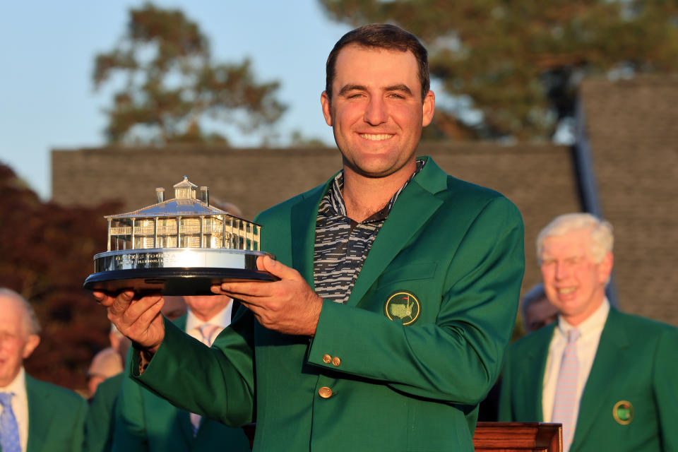 Pictured here, Scottie Scheffler posing with the Masters trophy during the green jacket ceremony at Augusta National.