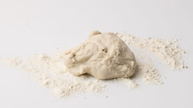 pizza dough on floured surface