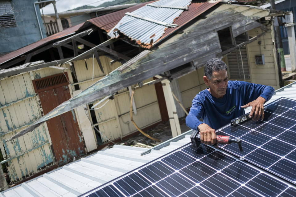 Julio Rosario installs a solar system on his home in Adjuntas, Puerto Rico. (Dennis M. Rivera Pichardo/ASSOCIATED PRESS)