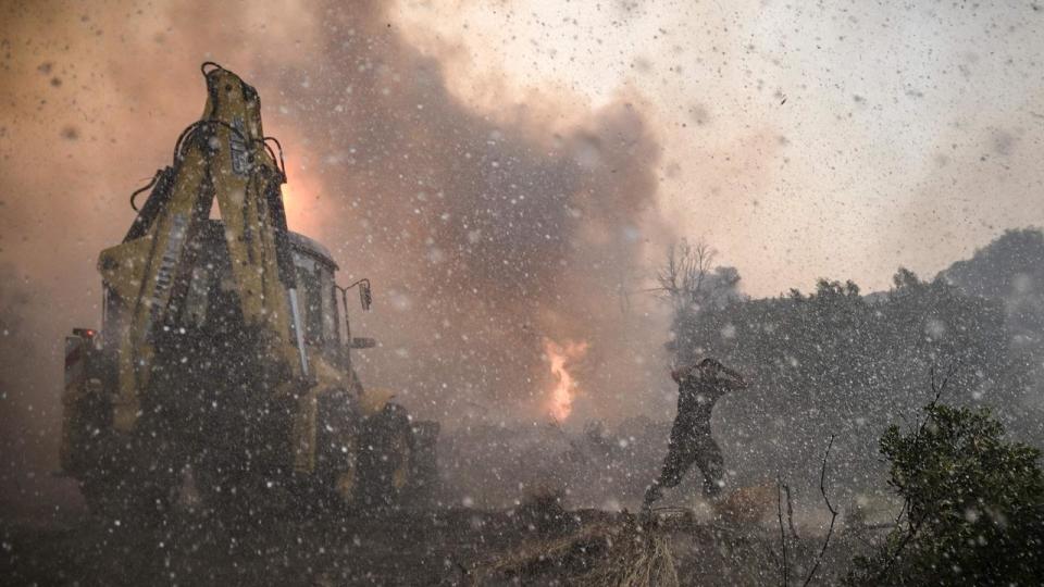 Wildfires have been raging in Greece amid scorching temperatures, forcing mass evacuations in tourist spots including on the islands of Rhodes and Corfu. Picture: Spyros Bakalis / AFP