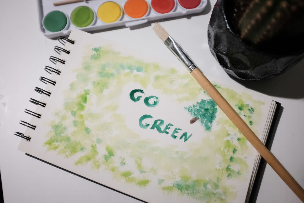 'Go Green' is painted on a drawing book in Athens, Greece on March 20, 2023.