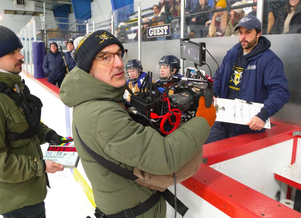 "Shattered Ice" director of photography Rubin Steinberg lines up his shot with actor Jack Falahee, right, who plays hockey coach Dave Dunn on Wednesday, Jan. 24, 2024.