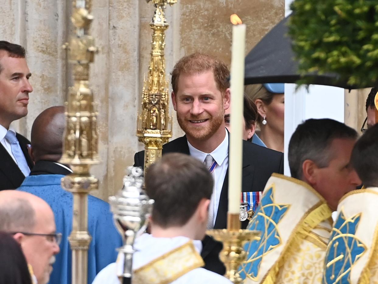 Harry smiling as he leaves