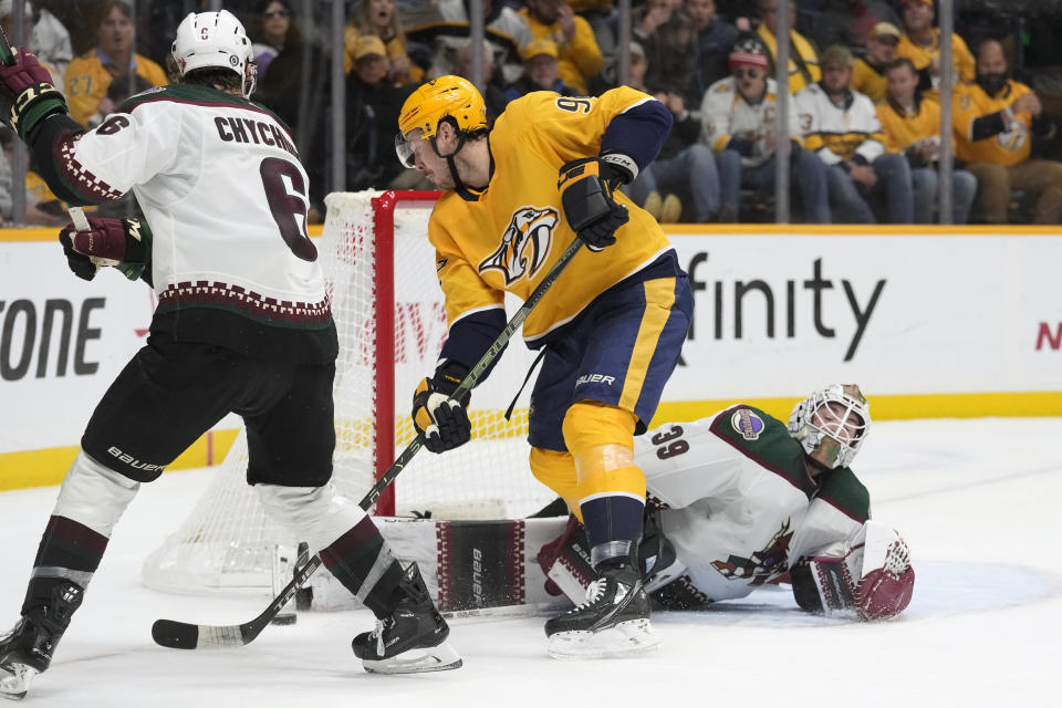 Arizona Coyotes goaltender Connor Ingram (39) blocks a shot by Nashville Predators' Ryan Johansen (92) in the third period of an NHL hockey game Monday, Nov. 21, 2022, in Nashville, Tenn. (AP Photo/Mark Humphrey)