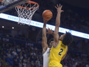 Penn State's Kebba Njie goes to the basket on Michigan's Kobe Bufkin (2) during the first half of an NCAA college basketball game, Sunday, Jan. 29, 2023, in State College, Pa. (AP Photo/Gary M. Baranec)