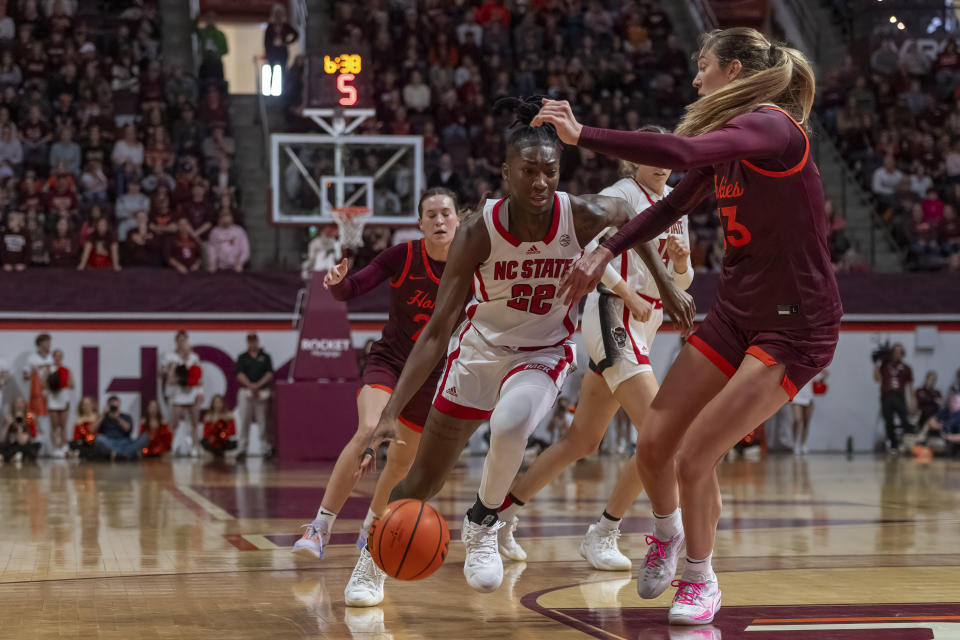 NC State's Saniya Rivers dribbles the ball as Virginia Tech's Elizabeth Kitley defends during the first half of an NCAA college basketball game, Sunday, Jan. 7, 2024, in Blacksburg, Va. (AP Photo/Robert Simmons)