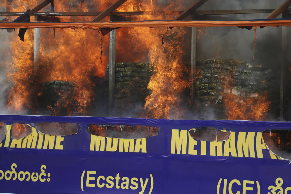 Flames and smoke rise from burning illegal drugs during a destruction ceremony to mark International Day against Drug Abuse and Illicit Trafficking outside Yangon, Myanmar, Friday, June 26, 2020. More than $839 million of seized illegal drugs were destroyed in the country on Friday, officials said. Myanmar has long been a major source of illegal drugs for East and Southeast Asia, despite repeated efforts to crack down. (AP Photo/Thein Zaw)