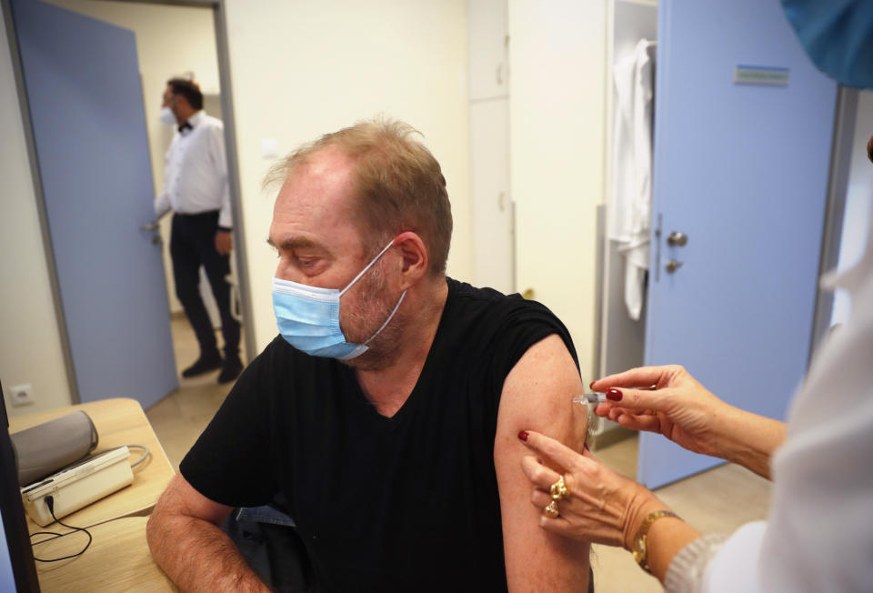 A man receives a Chinese made Sinopharm COVID-19 vaccine in Budapest, Hungary on Wednesday, Feb. 24, 2021. China is providing the vaccine to countries such as Serbia and Hungary -- a significant geopolitical victory in Central Europe and the Balkans, where the West, China and Russia are competing for political and economic influence. (AP Photo/Laszlo Balogh)