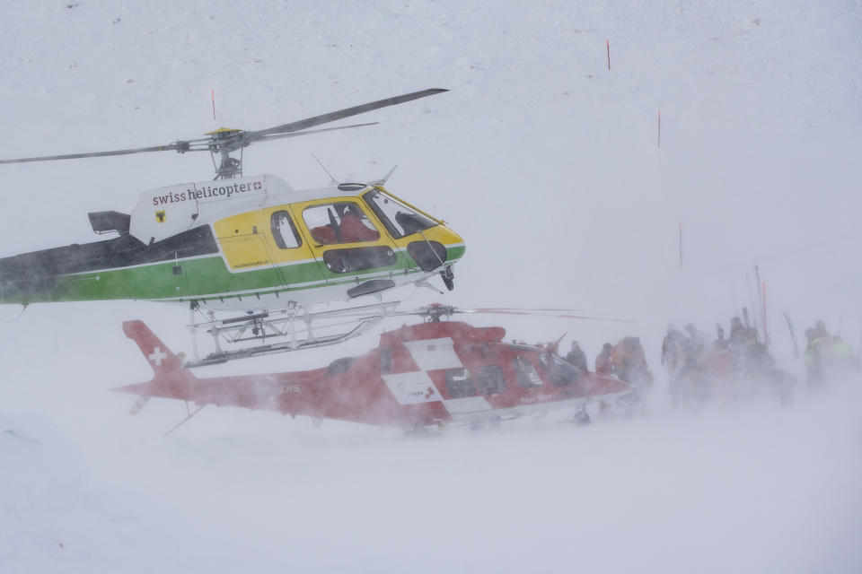 Rescue forces and helicopters search for missing people after an avalanche swept down a ski piste in the central town of Andermatt, canton Uri, Switzerland, Thursday, Dec. 26, 2019. The avalanche occurred mid-morning Thursday while many holiday skiers enjoyed mountain sunshine the day after Christmas. (Urs Flueeler/Keystone via AP)