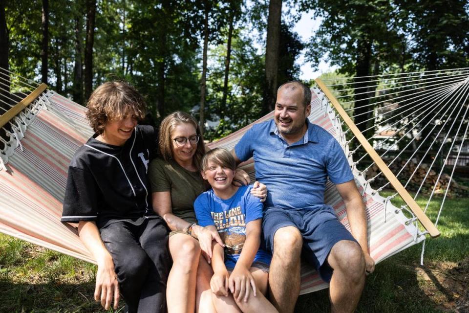 T.J., Amanda, Mike and Josh Dumas pose for a portrait at their Huntersville home. Mike, 12, is transgender and his family worries about a nationwide attempt to limit gender-affirming care for minors.