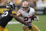 San Francisco 49ers running back Christian McCaffrey, right, runs with the ball as Pittsburgh Steelers linebacker Elandon Roberts defends during the first half of an NFL football game, Sunday, Sept. 10, 2023, in Pittsburgh. (AP Photo/Matt Freed)